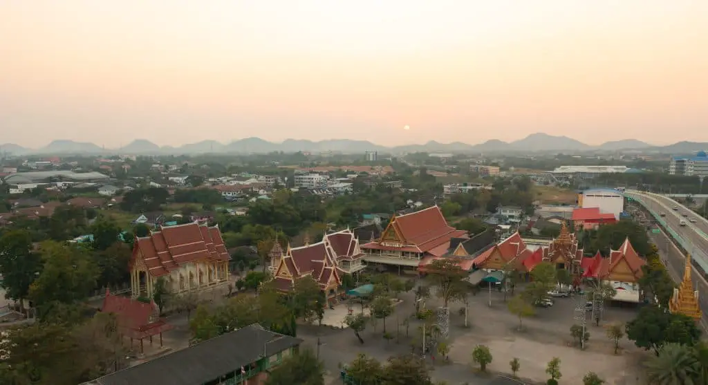 Aerial view of pagoda stupa.Temple Park, Ratchaburi, Thailand with urban city town. Thai buddhist temple architecture. Tourist attraction. Expat Kids School Transition Thailand